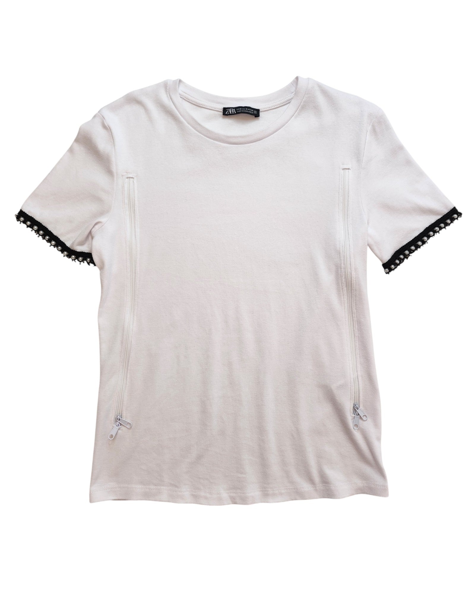 Laid flat on a white background, the upcycled Upcycled Breastfeeding (Nursing) & Pumping Plain White ZARA T-shirt M by touched out mama features short sleeves with decorative side zippers and black lace cuffs.
