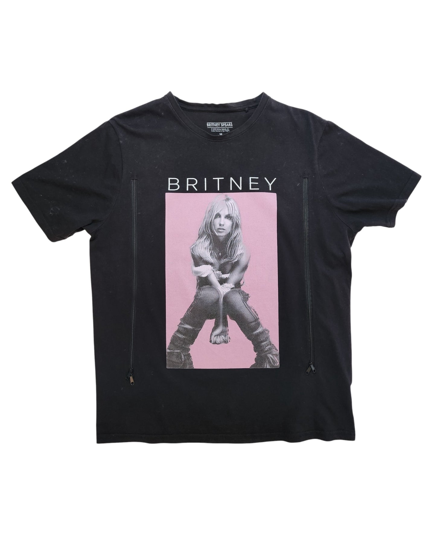 This preloved black Upcycled Breastfeeding & Pumping Britney T-shirt by touched out mama features a striking photo of a person sitting with hands on knees, highlighted by a pink rectangle and bold BRITNEY text, making it stylish and sustainably fashionable.