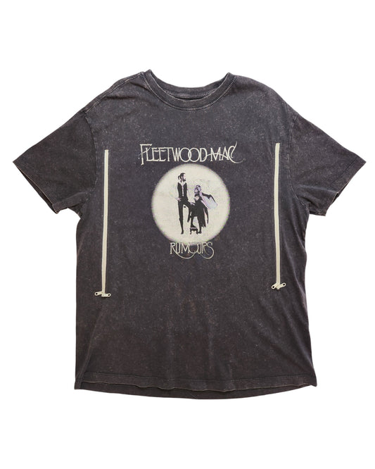 A faded black upcycled t-shirt by touched out mama in size UK16 features a Fleetwood Mac Rumours design with a silhouetted figure in flowing garments against a circular background, prominently displaying the brand name and album title.
