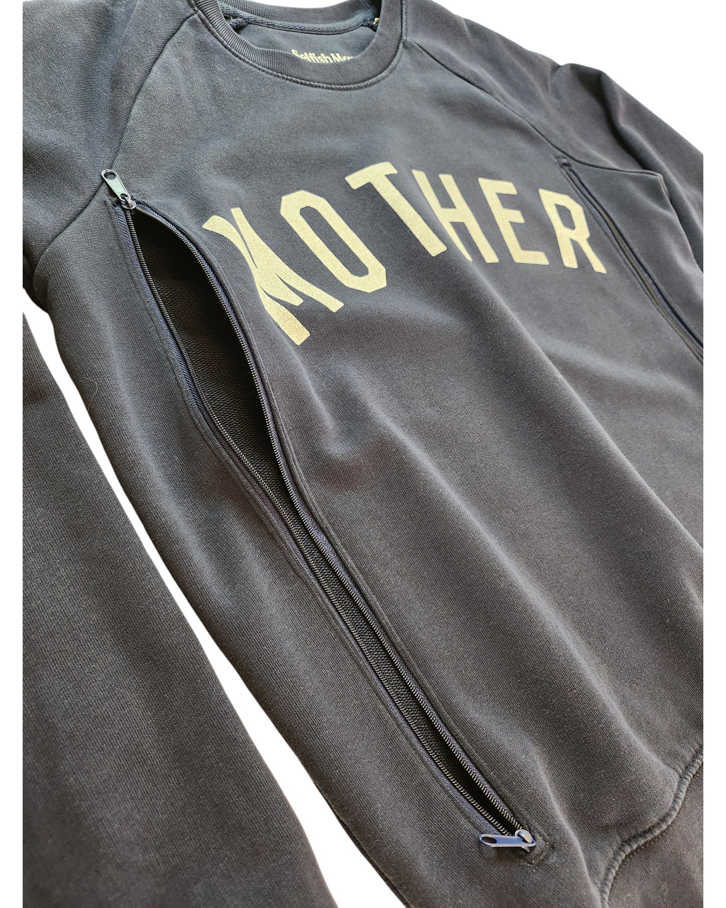 Close-up of the touched out mama Upcycled Breastfeeding & Pumping Mother Sweatshirt M in black with MOTHER in beige, side zippers for nursing, and crafted with an eco-friendly, modern design.