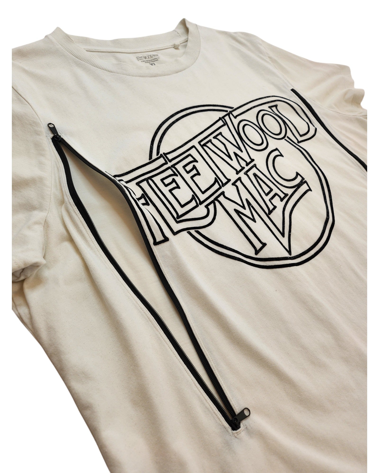 The Fleetwood Mac Upcycled Breastfeeding & Pumping White/Black t-shirt (XL) features black lettering, two diagonal black zippers across the chest for nursing or pumping access, and is crafted from upcycled clothing for sustainability.