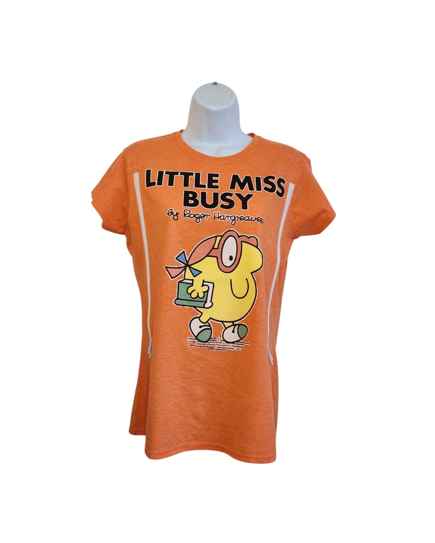 The Truffle Shuffle Upcycled Breastfeeding & Pumping Little Miss Busy t-shirt (M) on a mannequin features a cartoon and “LITTLE MISS BUSY by Roger Hargreaves” in bold—an eco-friendly, playful style for nursing moms.
