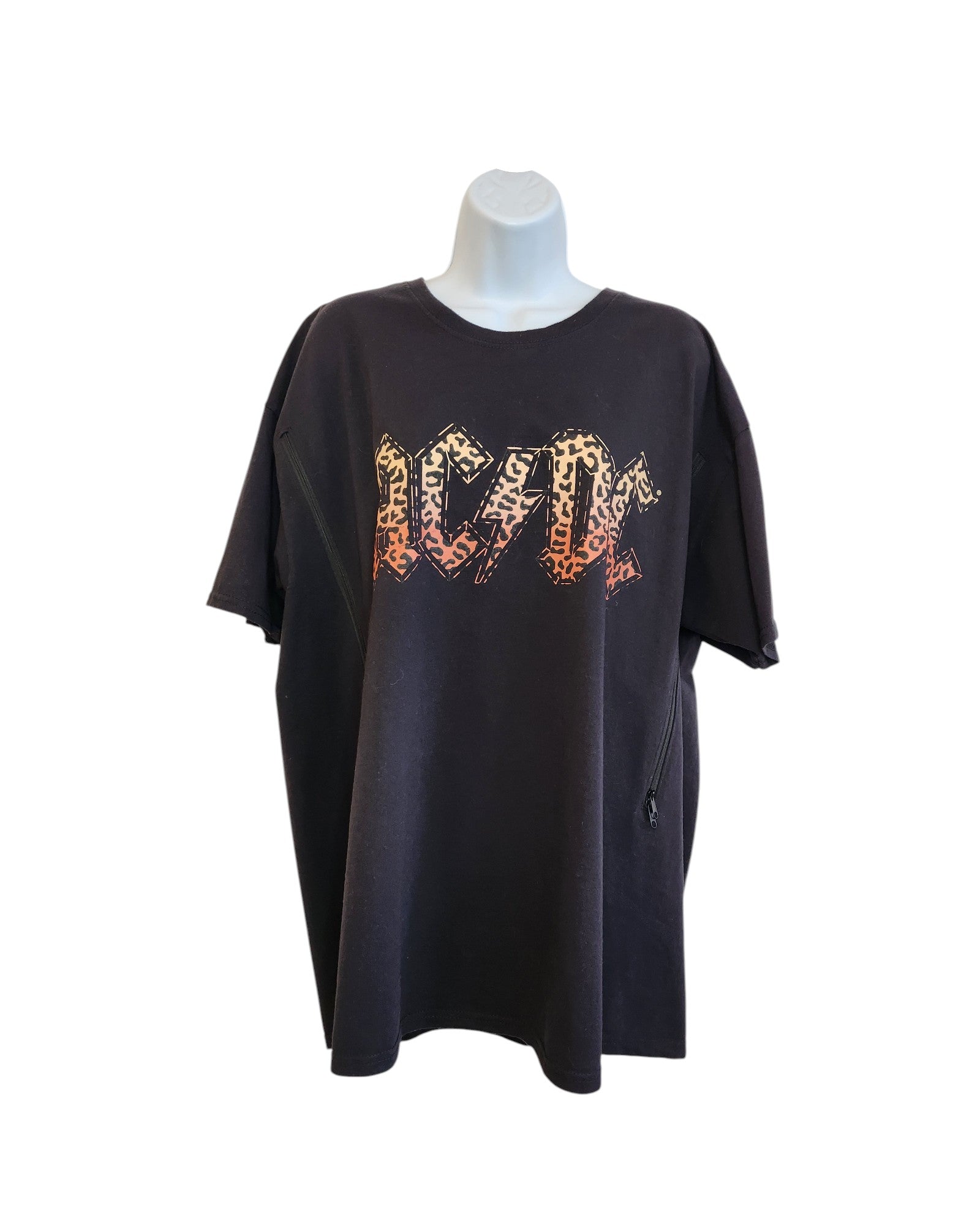 An upcycled 2XL AC/DC band tee for breastfeeding and pumping features a bold leopard print design, blending rock style with practical preloved fashion—ideal for any nursing music fan.