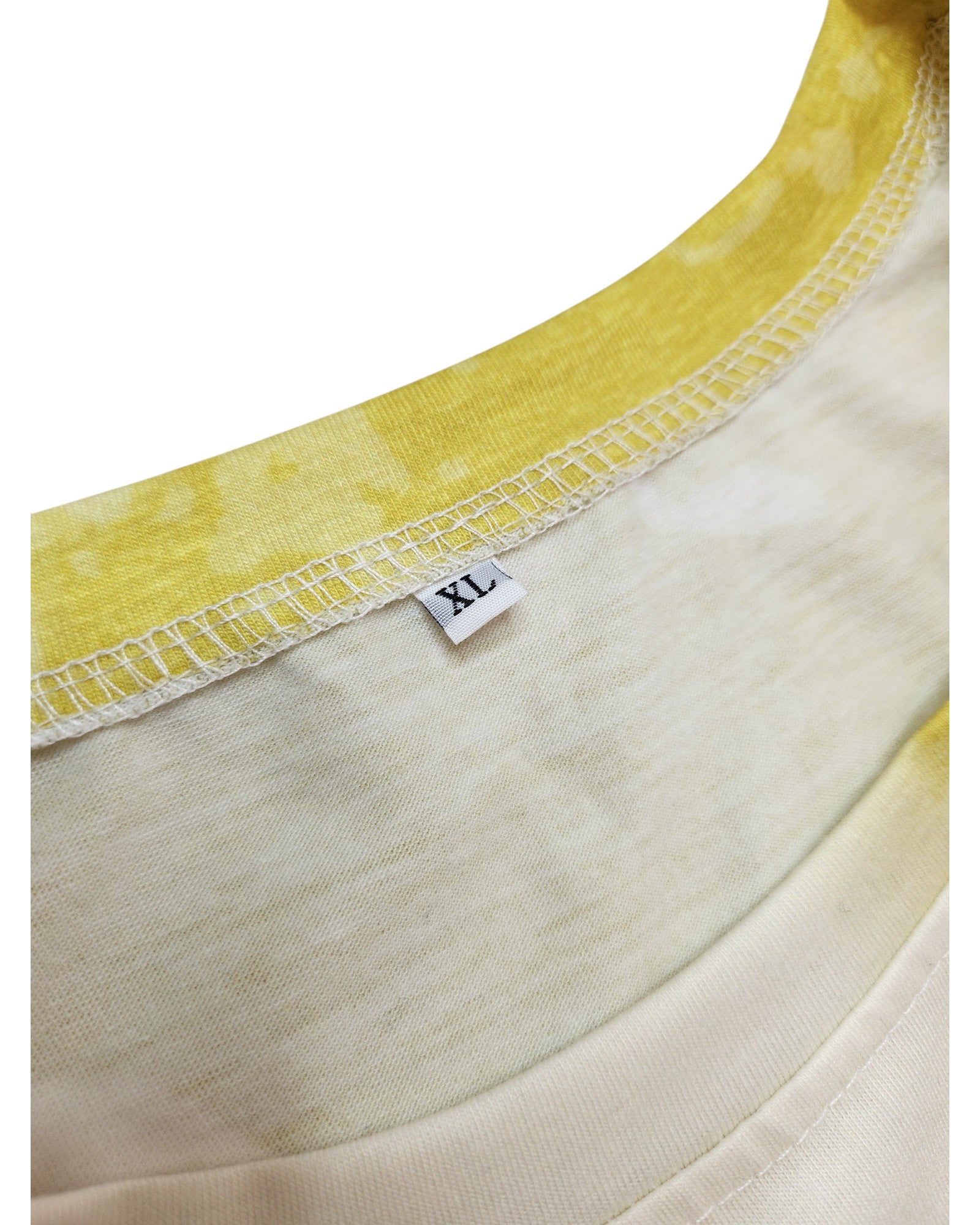 Close-up of an XL Upcycled Breastfeeding & Pumping Lime Fleetwood Mac t-shirt with a white size tag, yellow and white tie-dye pattern, visible seams, and made from eco-friendly materials. Brand unknown.