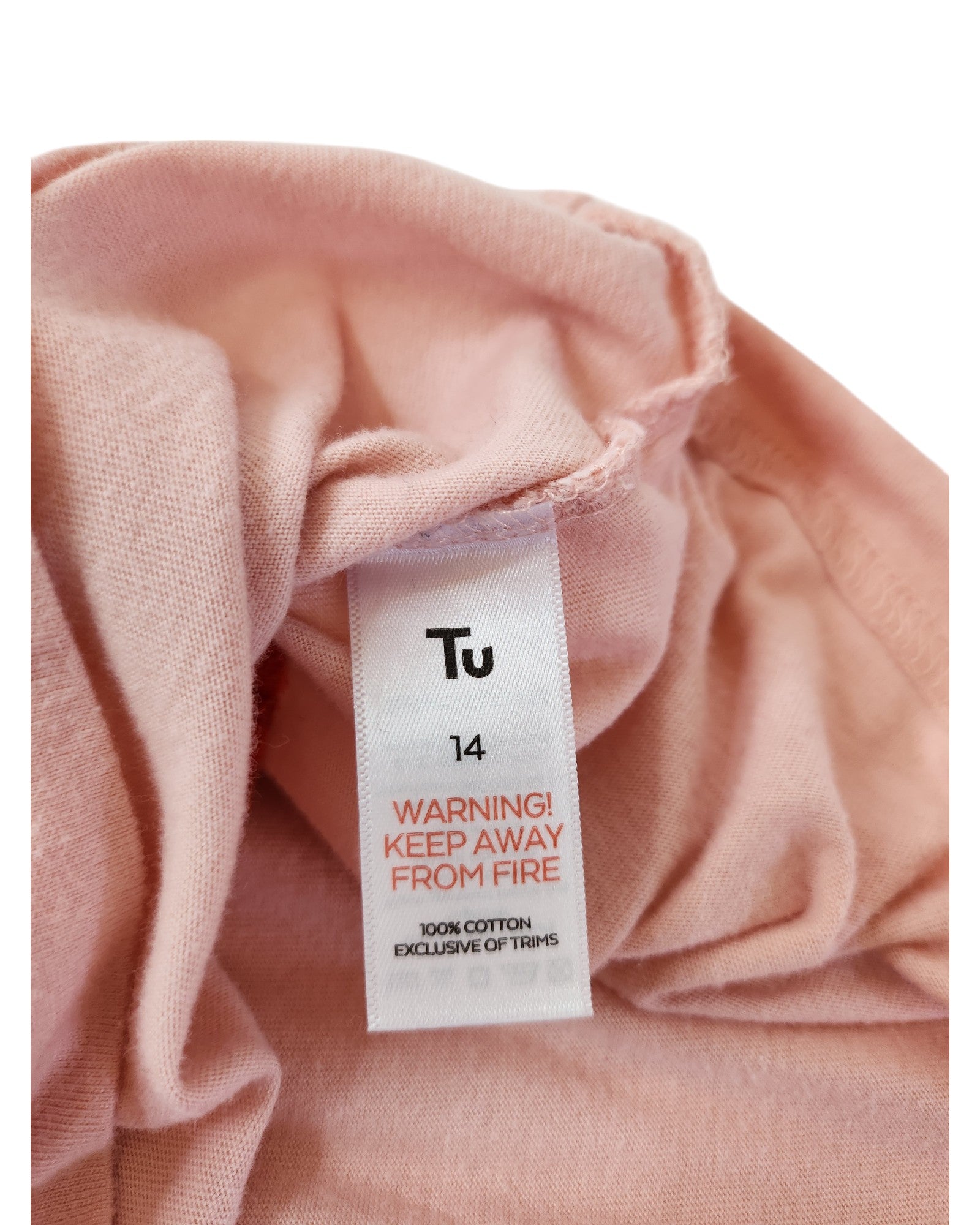 A close-up of the tag on this upcycled Tu pink The Rolling Stones breastfeeding & pumping t-shirt (UK14) shows the brand, size 14, a red KEEP AWAY FROM FIRE warning, and states its 100% cotton exclusive of trims.