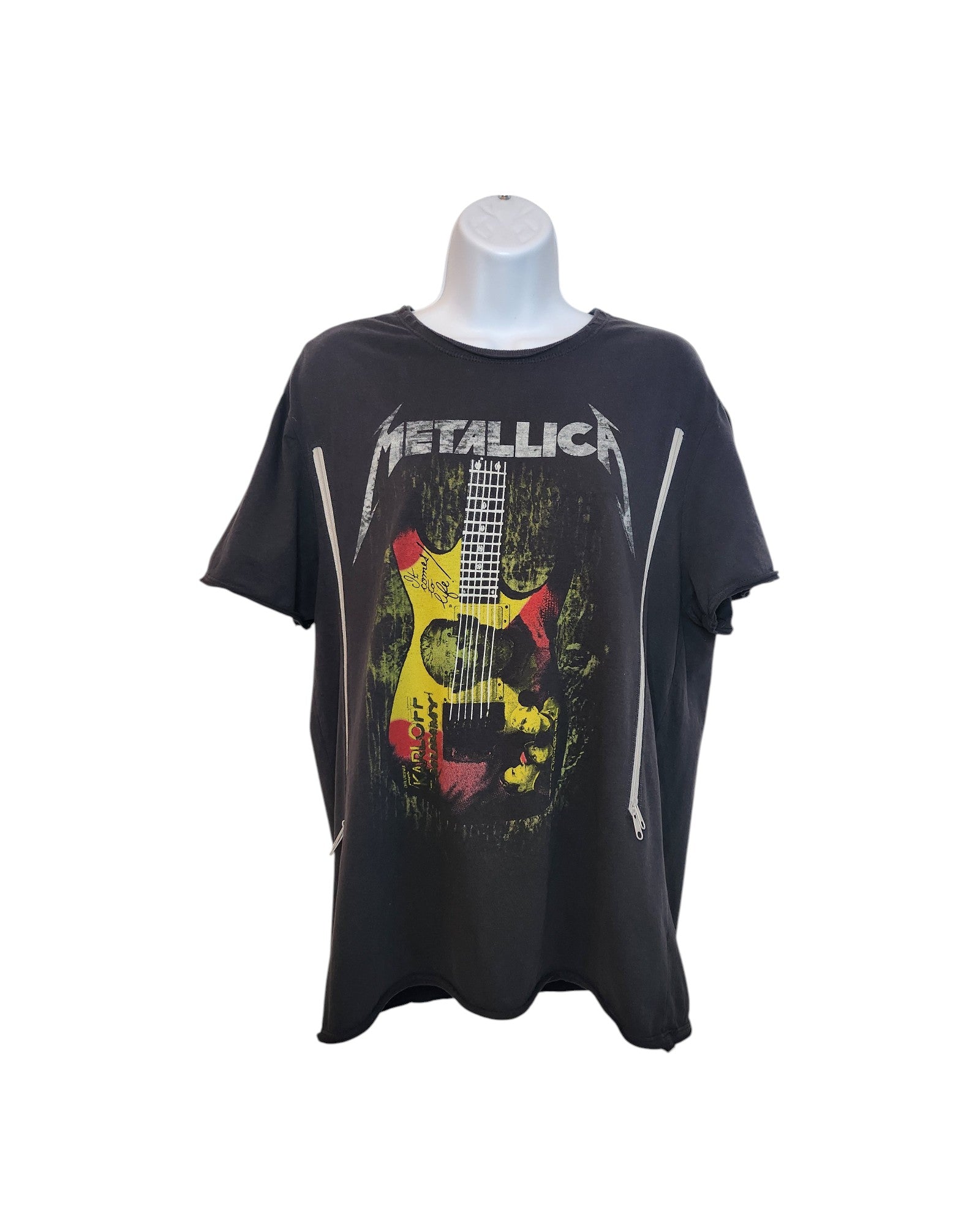 The Amplified Upcycled Breastfeeding & Pumping Metallica Guitar Band t-shirt (M) features a black short-sleeve design, the Metallica logo, red/yellow/white guitar graphic, and two vertical front zippers. Shown on a mannequin torso.