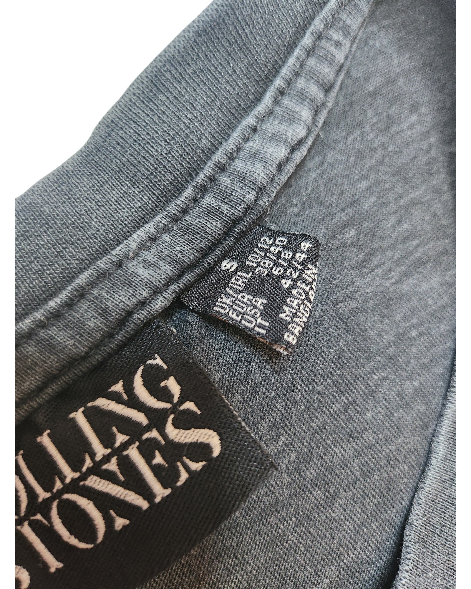 Close-up of a Primark Rolling Stones S (UK10/12) upcycled breastfeeding & pumping t-shirt dress in soft grey, showing two tags—one with the brand and one with size and care details. Preloved and comfortable for nursing moms.