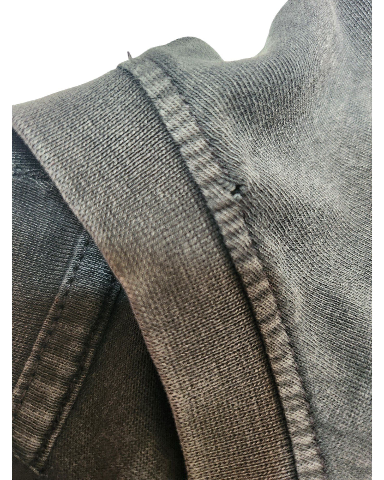 Close-up of the Primark Upcycled Breastfeeding & Pumping Nirvana Band T-shirt (XS, UK6/8) in dark grey/red floral. Thick seam and stitching details highlight the denim-like textured fabric under soft lighting on a white background.