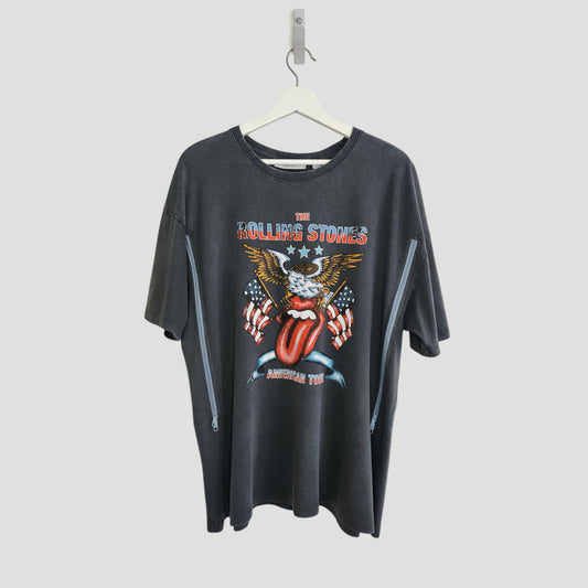 An upcycled black Rolling Stones US t-shirt (size L) by The Rolling Stones, designed for breastfeeding and pumping—features the band’s iconic graphics and “American Tour” on the front; displayed on a hanger against a white background.