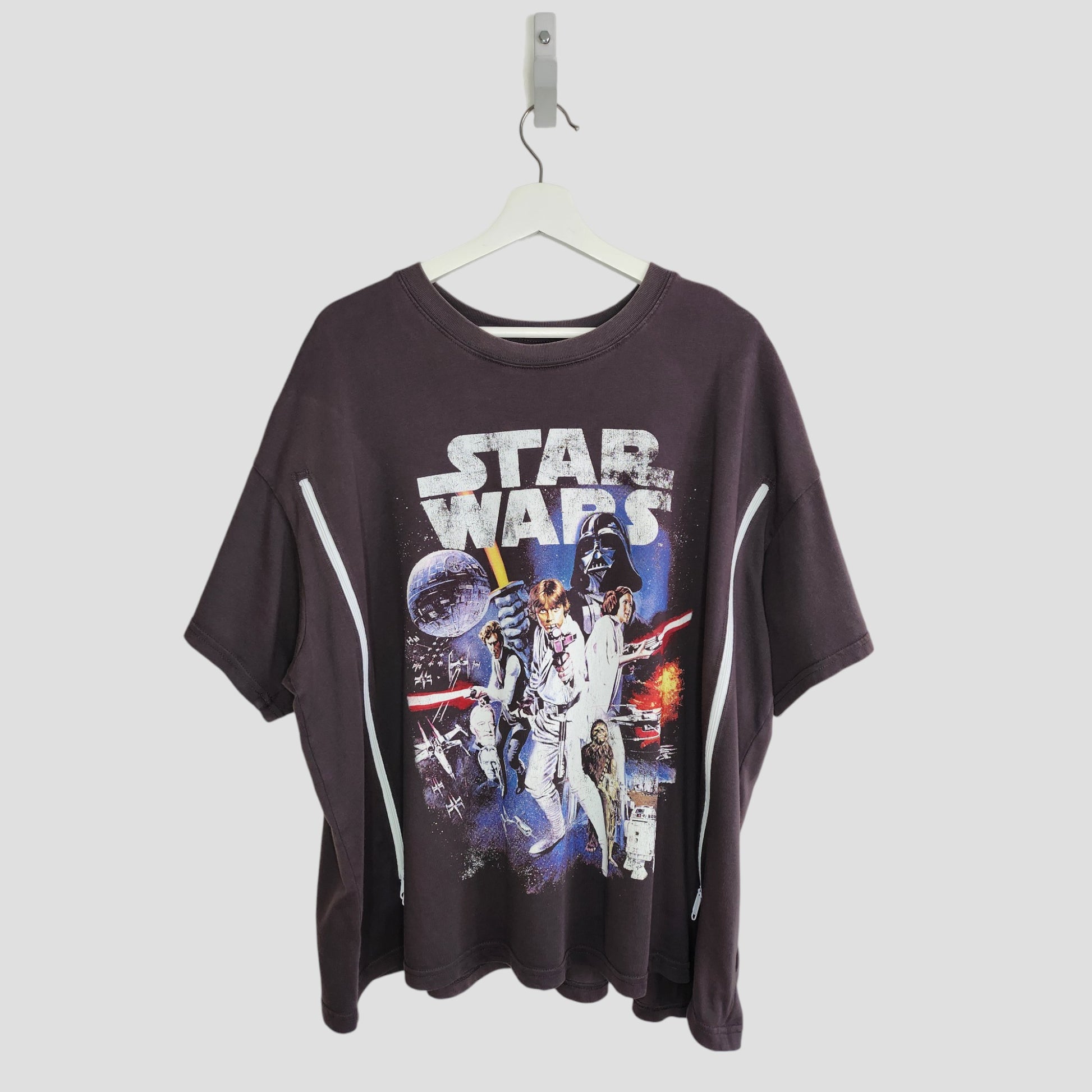 An upcycled H&M Grey Star Wars nursing & pumping t-shirt (XL), featuring character and spaceship graphics, made from preloved materials. Displayed on a white hanger against a plain background.