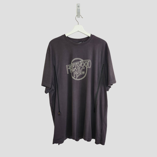 The Primark Upcycled Breastfeeding & Pumping Black/White Fleetwood Mac t-shirt 3XL, made from eco fashion materials, with a white outlined logo on the chest, hangs on a white hanger against a light gray background.
