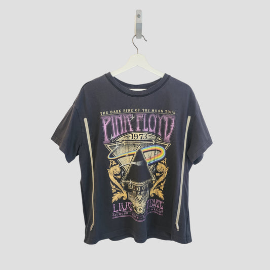A grey upcycled H&M Pink Floyd breastfeeding & pumping band t-shirt (size M) hangs on a white hanger, featuring colorful prism and rainbow graphics inspired by The Dark Side of the Moon Tour 1973.