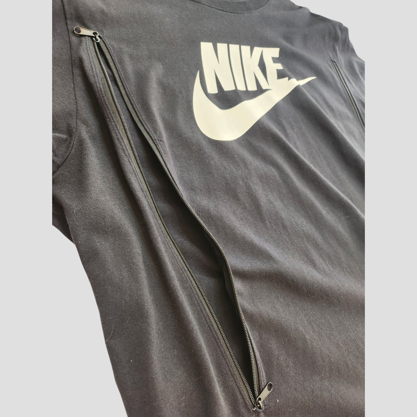 An upcycled XL Nike t-shirt in black with a white Nike tick, featuring front zippers for breastfeeding or pumping—sustainable, preloved fashion for nursing moms.