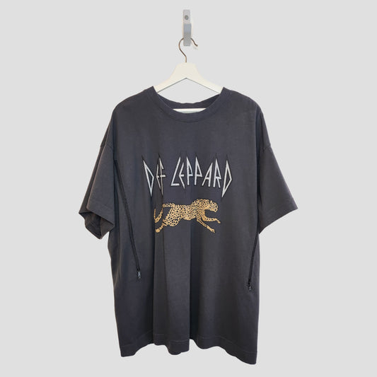 An H&M Upcycled Breastfeeding & Pumping Def Leppard t-shirt XL (100257), featuring a bold band logo and running leopard, is displayed on a white hanger against a plain background.