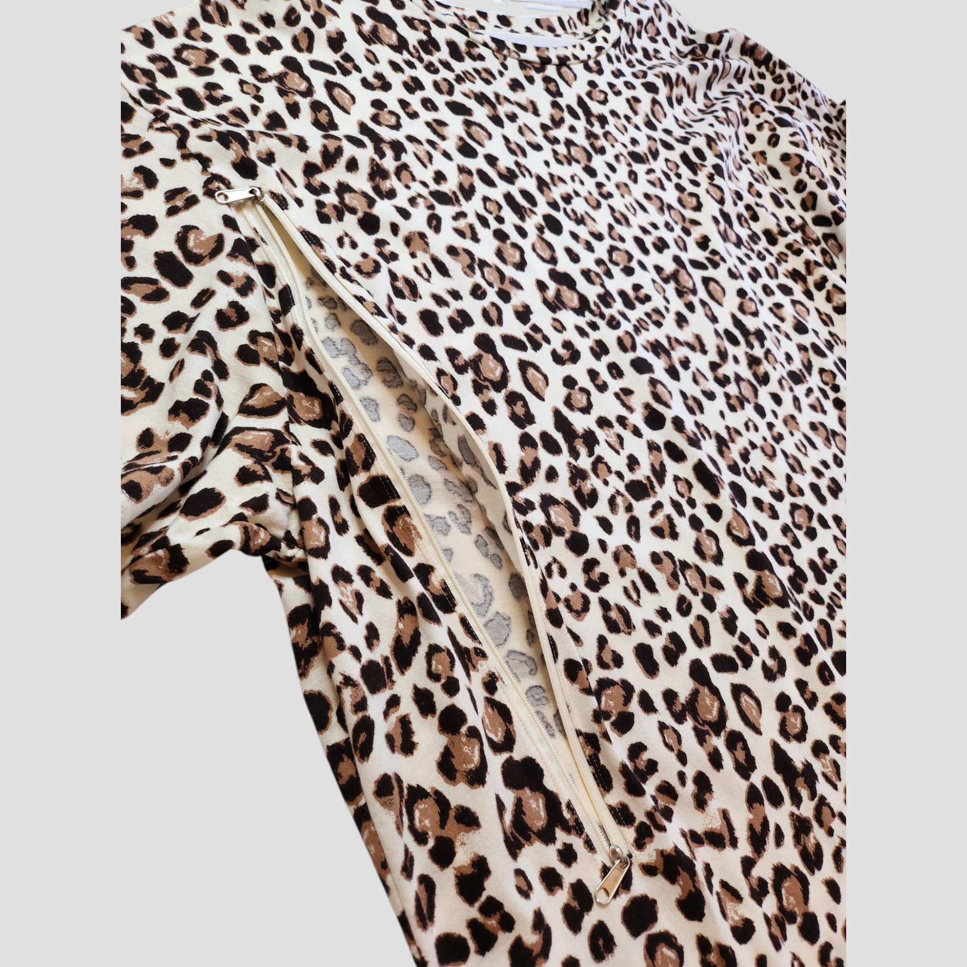 A close-up of the New Look Upcycled Breastfeeding & Pumping Cream Leopard t-shirt UK26 shows a side diagonal zipper revealing the matching animal print lining.
