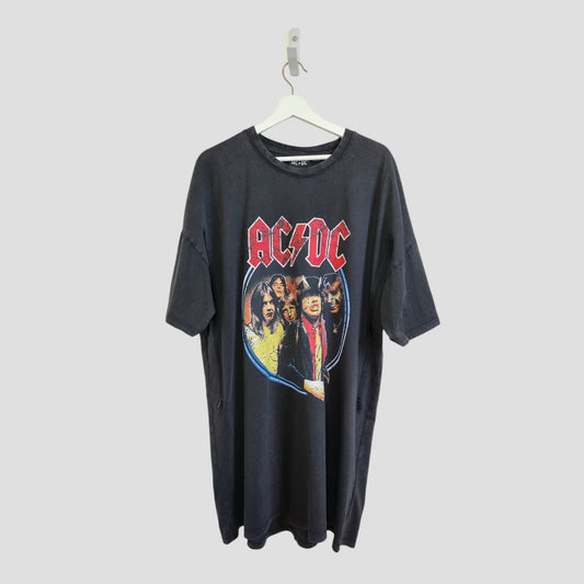 An upcycled Primark AC/DC Faces Band oversized t-shirt dress for breastfeeding and pumping, size L (100245), hangs on a white hanger against a plain light background.