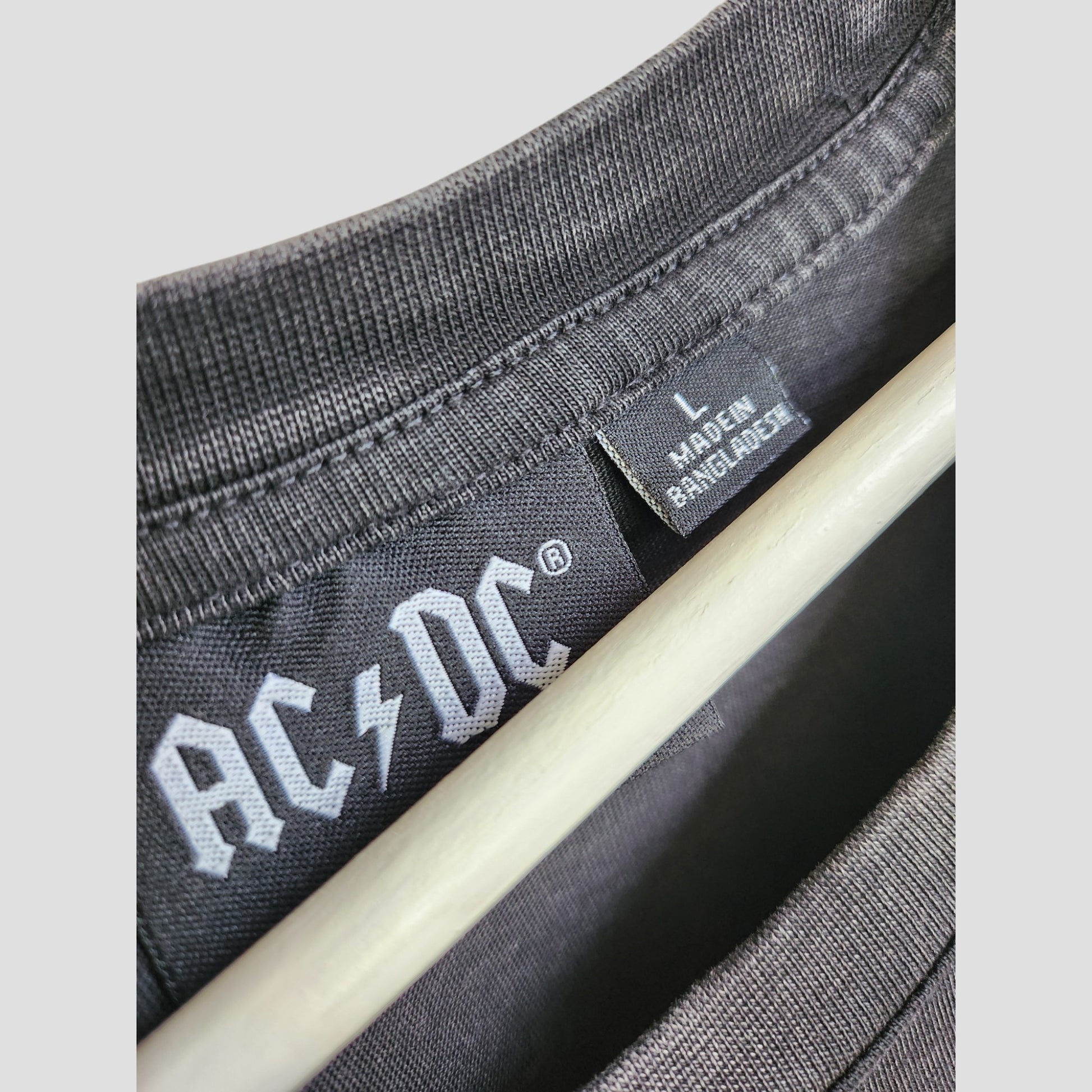 Close-up of a Primark Upcycled Breastfeeding & Pumping AC/DC Faces Band Oversized t-shirt dress in size L, made in Bangladesh—collar, inner band logo, and label visible; ideal eco-friendly maternity wear.