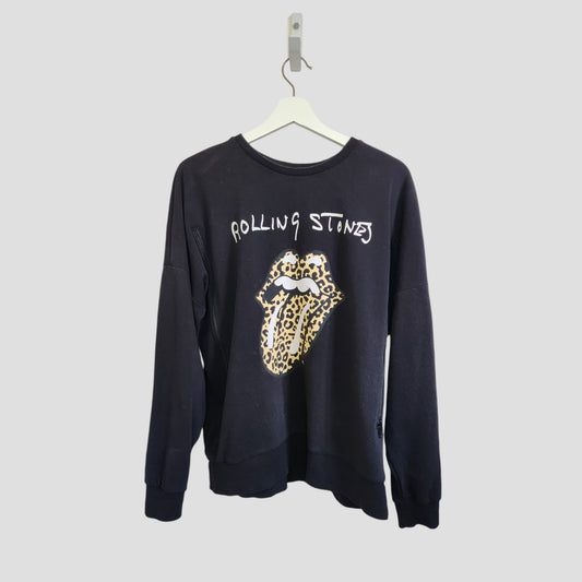 The Rolling Stones Upcycled Black/Leopard Band Sweatshirt (UK14, 100280) for breastfeeding and pumping, made from preloved clothing, features a leopard print tongue and lips graphic. Displayed on a white hanger against a light gray background.