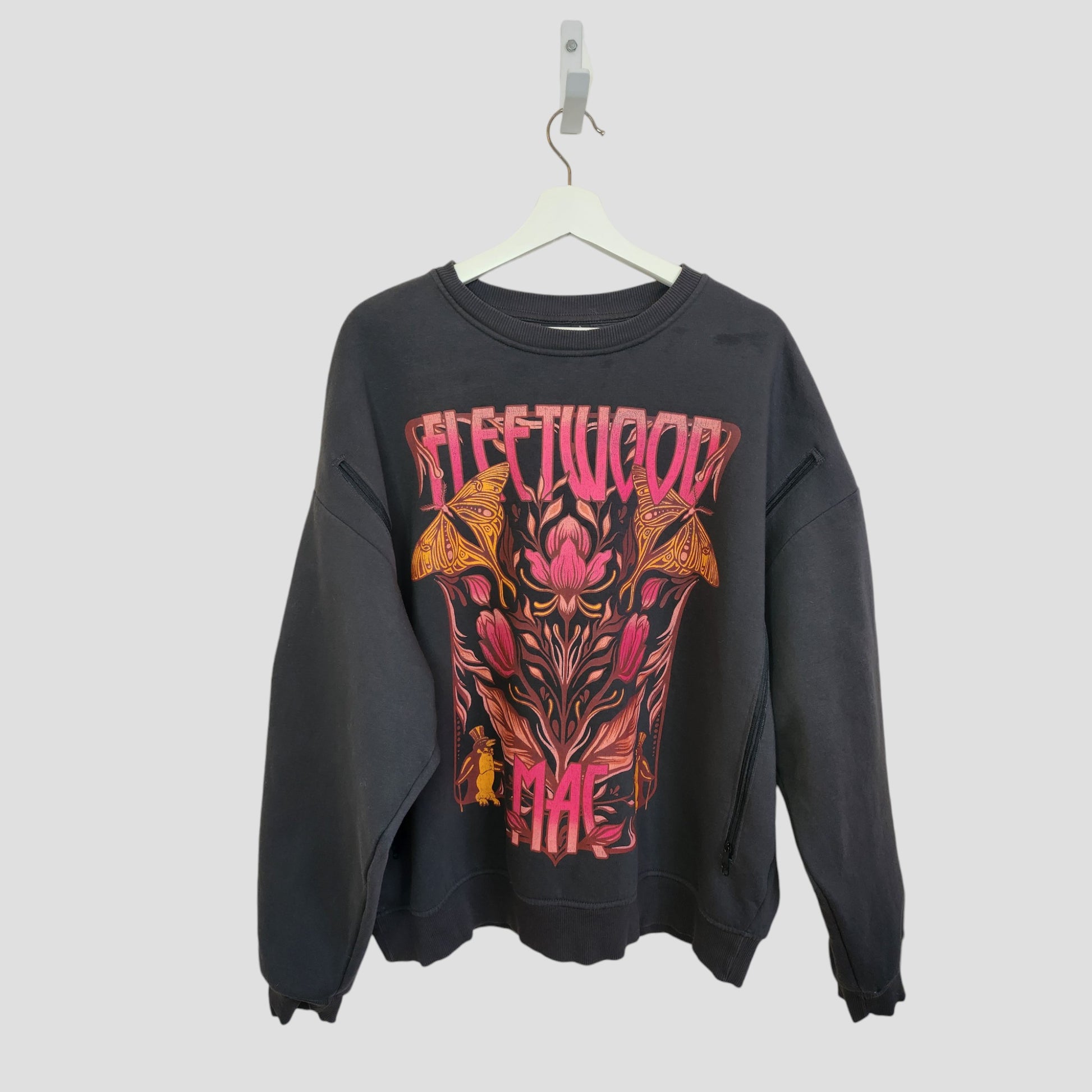 Primark's upcycled dark grey Fleetwood Mac sweatshirt (L, UK14/16) features a vibrant floral and moth band design on the front—repurposed from breastfeeding clothing for eco-friendly style.