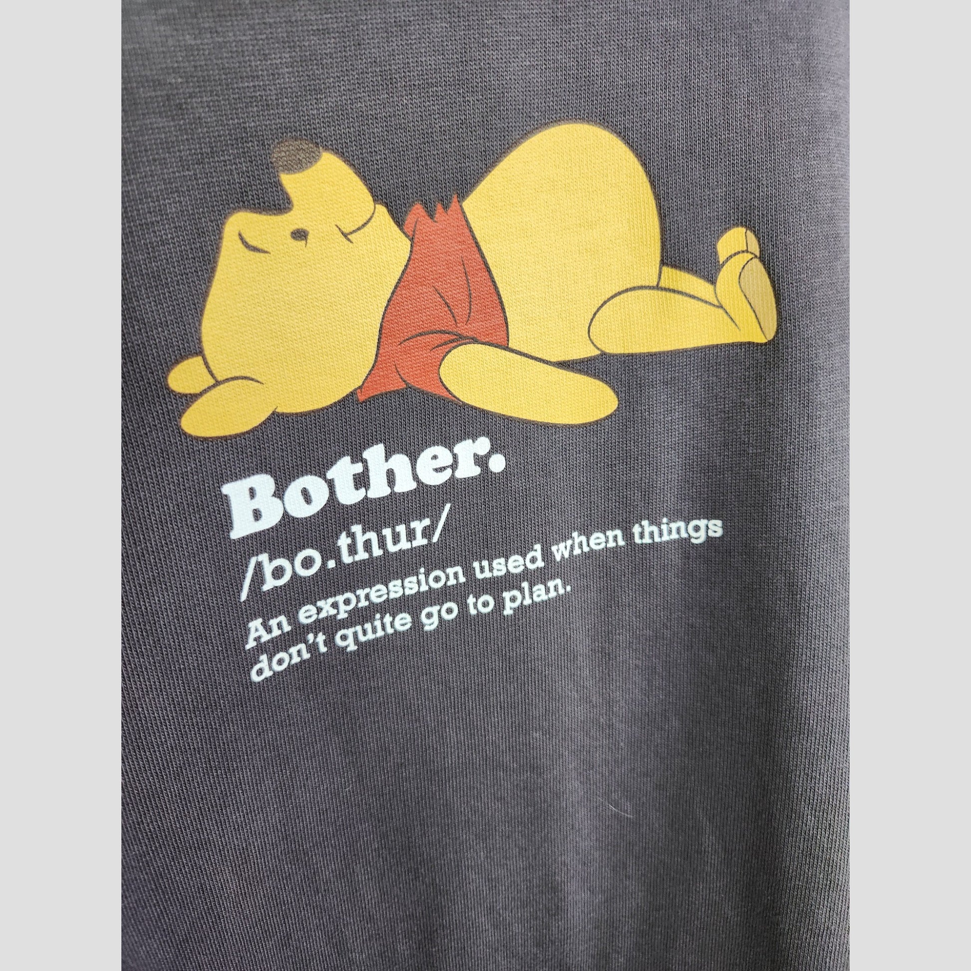 Winnie the Pooh lies on his back above "Bother." Text below explains it’s for when things don’t go to plan—just like hunting for upcycled nursing or pumping wear, like this George Upcycled Breastfeeding & Pumping Pooh Bother Sweatshirt L (100126).