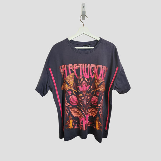 A dark grey Primark Fleetwood Mac band tee (UK14/16) hangs on a white hanger. This upcycled breastfeeding/pumping top features bold pink and orange floral graphics with vertical pink side stripes.