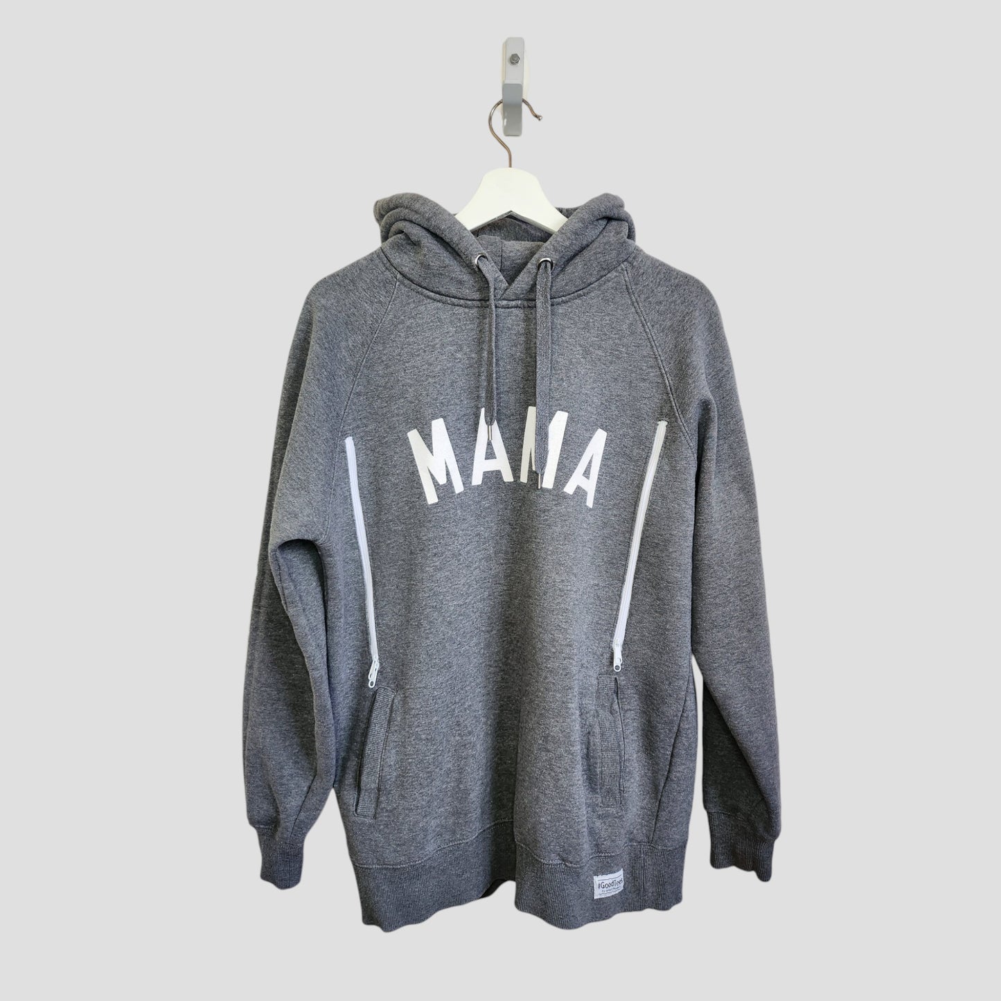 The Selfish Mother Upcycled Breastfeeding & Pumping MAMA Hoodie L (100130) features "MAMA" in white capitals on gray, crafted from upcycled materials, and is shown on a white hanger against a light gray background.