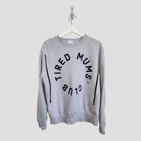 The Momma Makes Upcycled Breastfeeding & Pumping Tired Mums Club Sweatshirt M (100190) features “TIRED MUMS’ CLUB” in bold black letters on gray—an eco-friendly maternity essential for comfort and style.