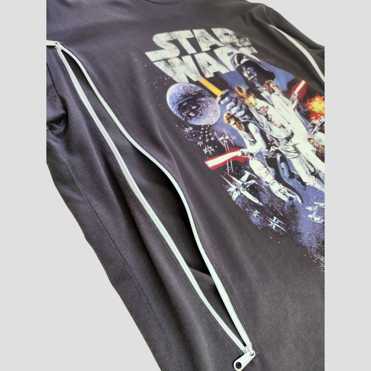 An upcycled grey Star Wars nursing & pumping t-shirt (size M) by H&M—eco-friendly and perfect for fans seeking unique preloved clothing.