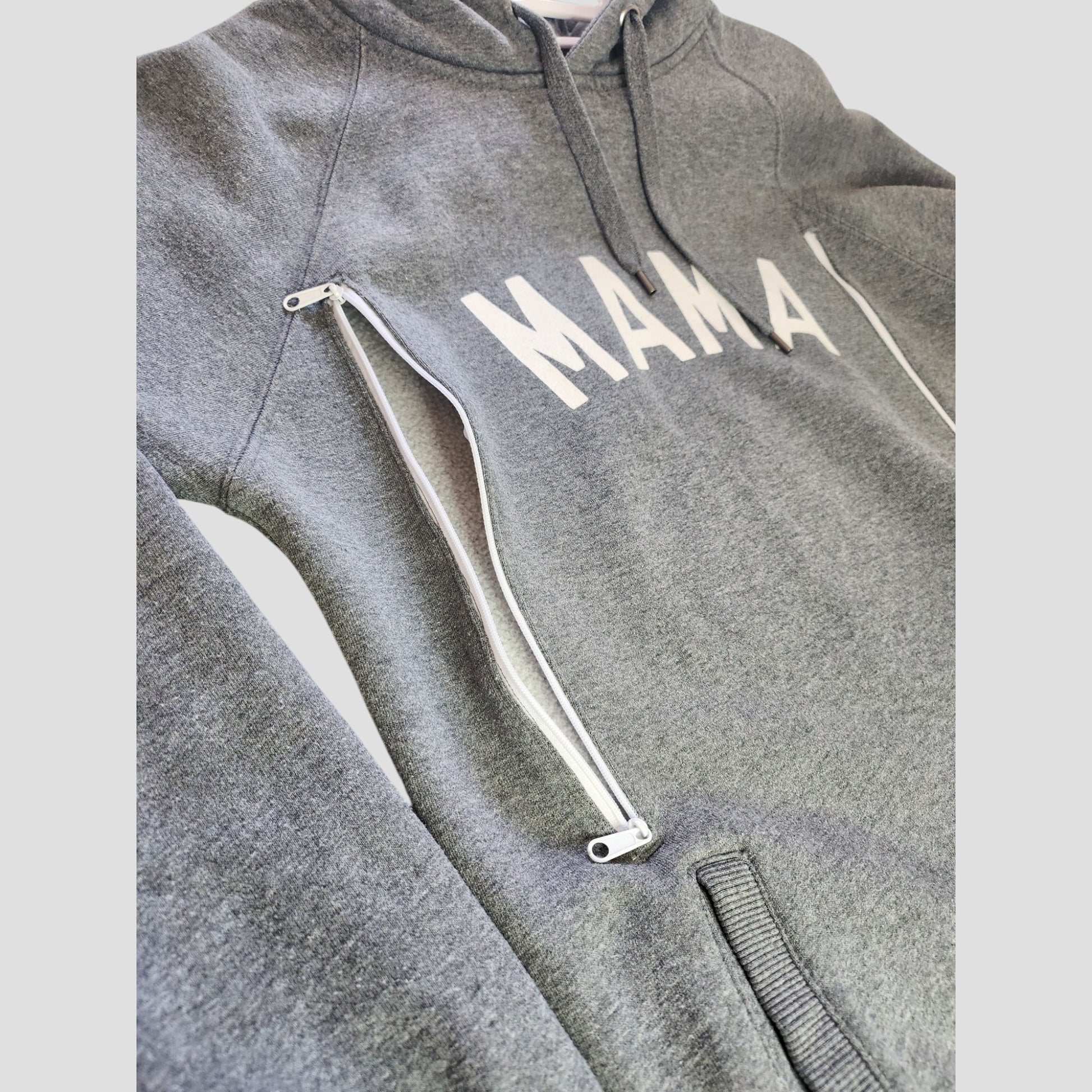 The Selfish Mother Upcycled Breastfeeding & Pumping MAMA Hoodie L (100130) is a grey hoodie with "MAMA" in white across the chest, featuring a left-side zipper for easy nursing—an eco-friendly and stylish maternity choice.