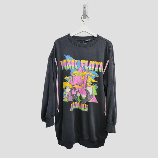 A black upcycled Pink Floyd long oversized sweatshirt by Primark (M, UK12/14) hangs on a white hanger, featuring a vibrant prism and clouds graphic—perfect for nursing or pumping and those seeking eco-friendly style.