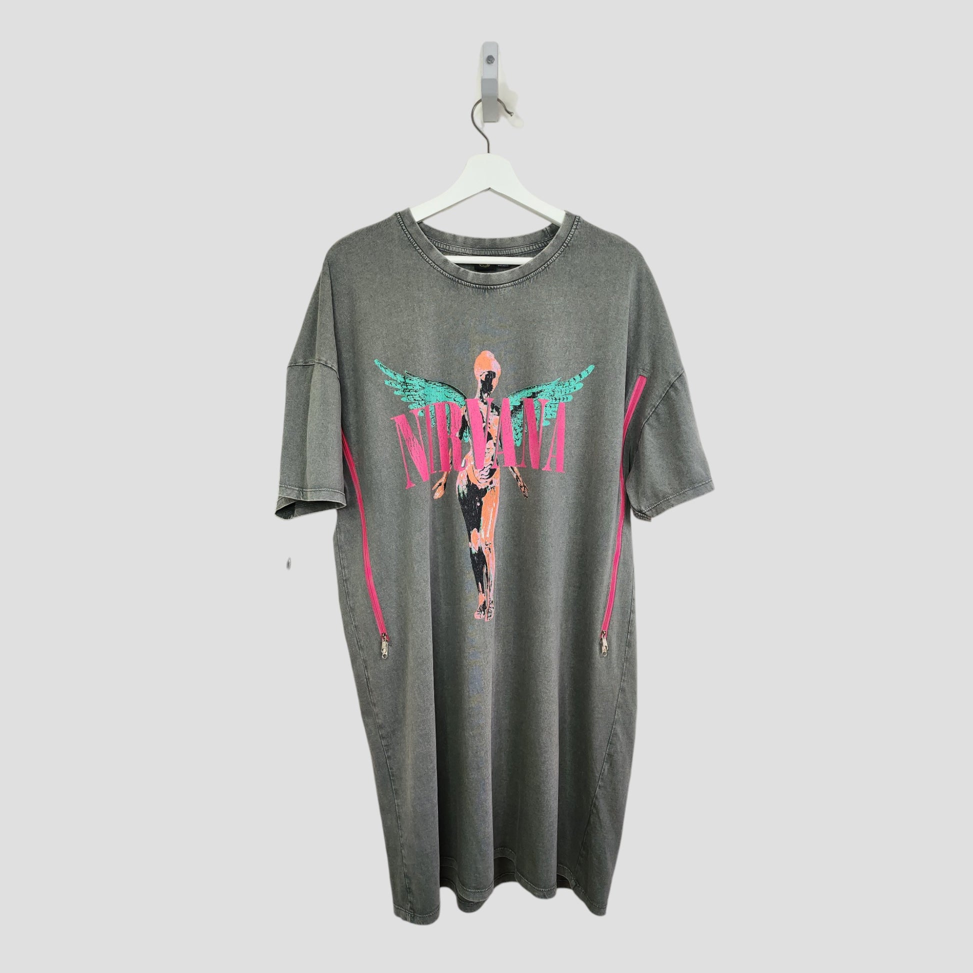 Primark Upcycled Breastfeeding & Pumping Grey/Pink Nirvana Angel Oversized Band t-shirt dress (M, UK12/14) crafted from preloved clothing, features a bold graphic and hangs on a white hanger against a plain background.