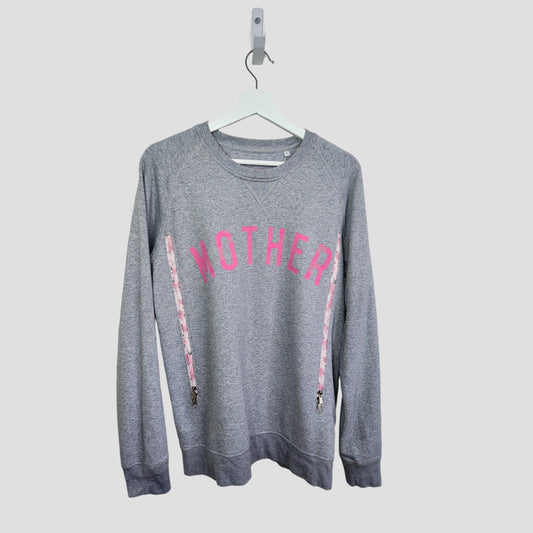 The Selfish Mother Upcycled Breastfeeding & Pumping Grey/Pink MOTHER Sweatshirt (L) features bold pink "MOTHER" lettering on organic cotton, shown on a white hanger against a plain light background.