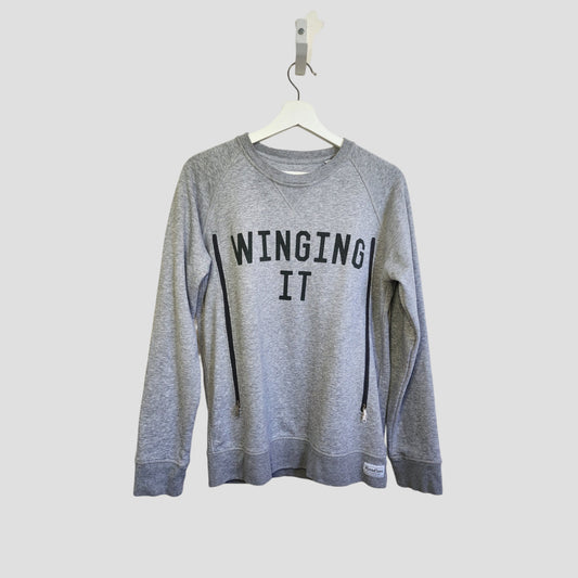 The Selfish Mother Upcycled Breastfeeding & Pumping Grey WINGING IT Sweatshirt (M) features bold black lettering and eco-friendly materials—ideal for nursing moms seeking style and sustainability.