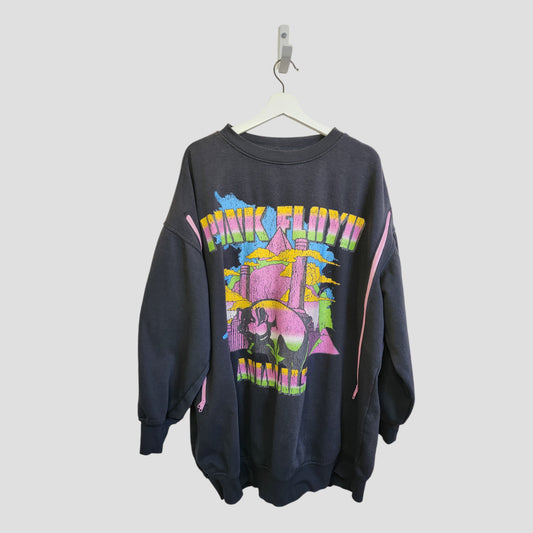 The H&M Upcycled Breastfeeding & Pumping Pink Floyd Band Oversized Sweatshirt (L, 100176) features a colorful abstract skull graphic and hangs on a white hanger against a light gray background—ideal for nursing fans of unique style.