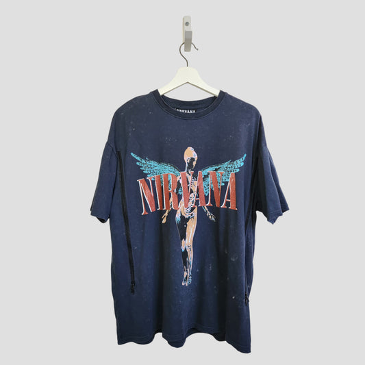 An oversized grey Nirvana Angel Band T-shirt by Primark, upcycled from breastfeeding clothing (M, UK12/14), hangs on a white hanger against a plain light gray background.