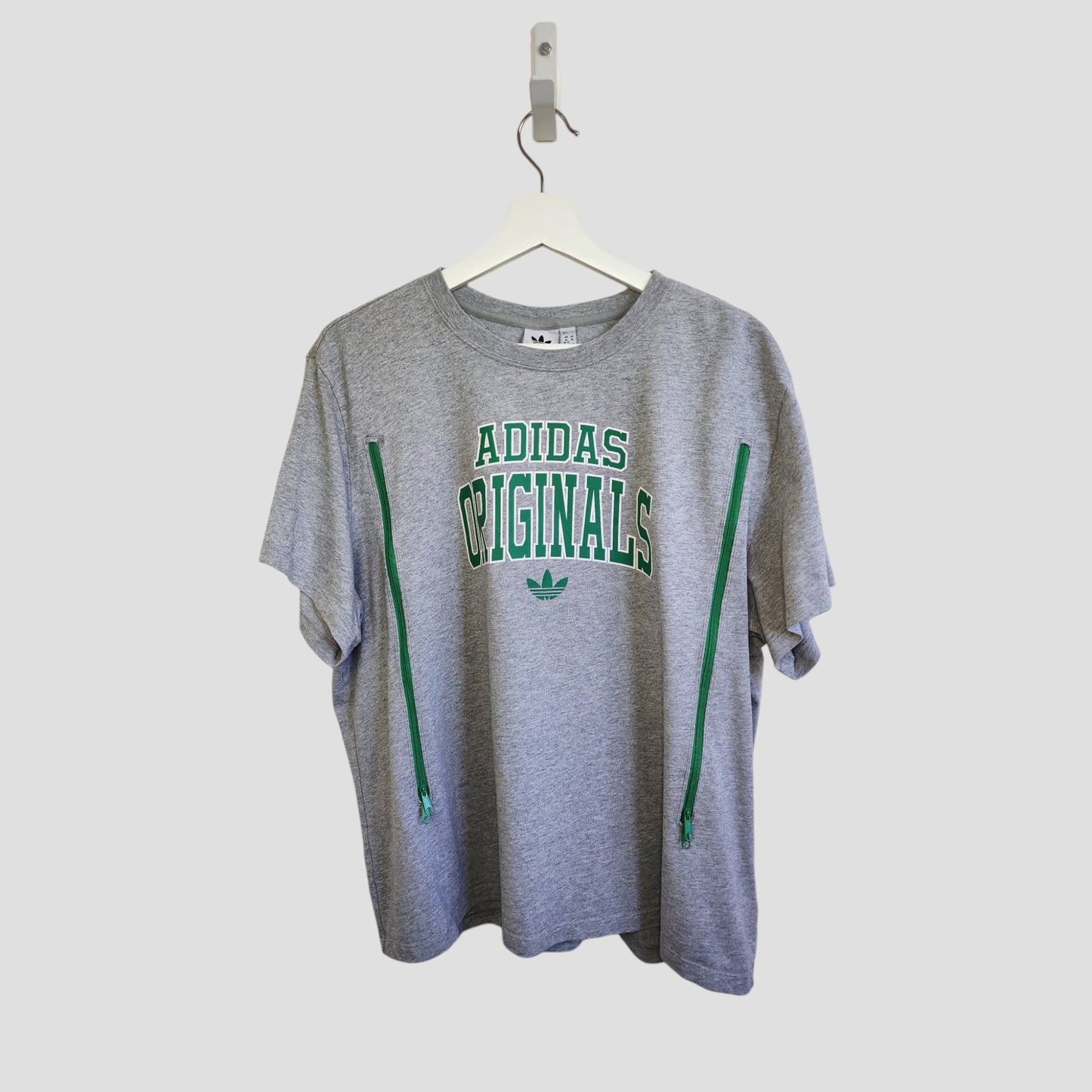 Adidas Upcycled Nursing & Pumping T-shirt XL (UK20/22) in grey with green accents and front zippers, eco-friendly preloved clothing, displayed on a white hanger against a plain background.