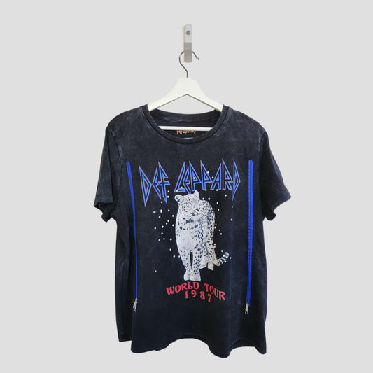 This upcycled Def Leppard Snow Band t-shirt (L) features a bold leopard graphic with blue accents and “Def Leppard” and “World Tour 1987” text. Stylish, sustainable, and designed for breastfeeding and pumping.