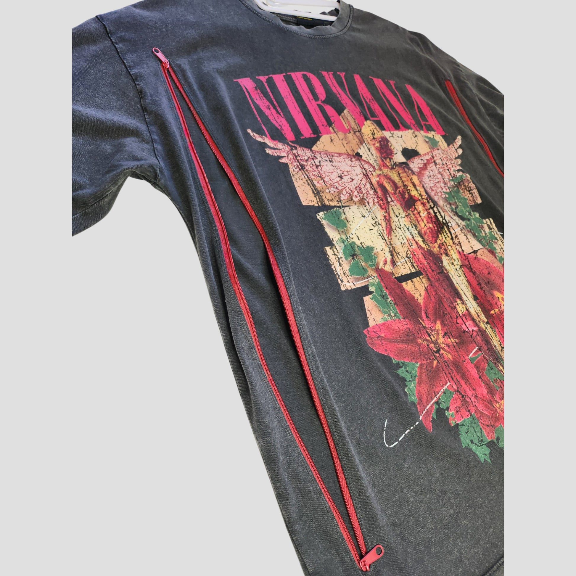 Primark Upcycled Breastfeeding & Pumping Nirvana Band Oversized Dark Grey Floral T-shirt (UK10/12) features a winged figure, red flowers, and distressed details. Eco-friendly design for nursing and pumping.