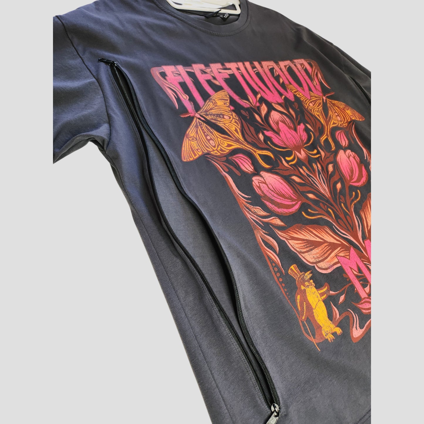 The Primark Upcycled Breastfeeding & Pumping Grey Fleetwood Mac Floral Band Oversized T-shirt (S, UK10/12) features a floral graphic and side zipper for easy nursing, combining comfort and eco-friendly style.