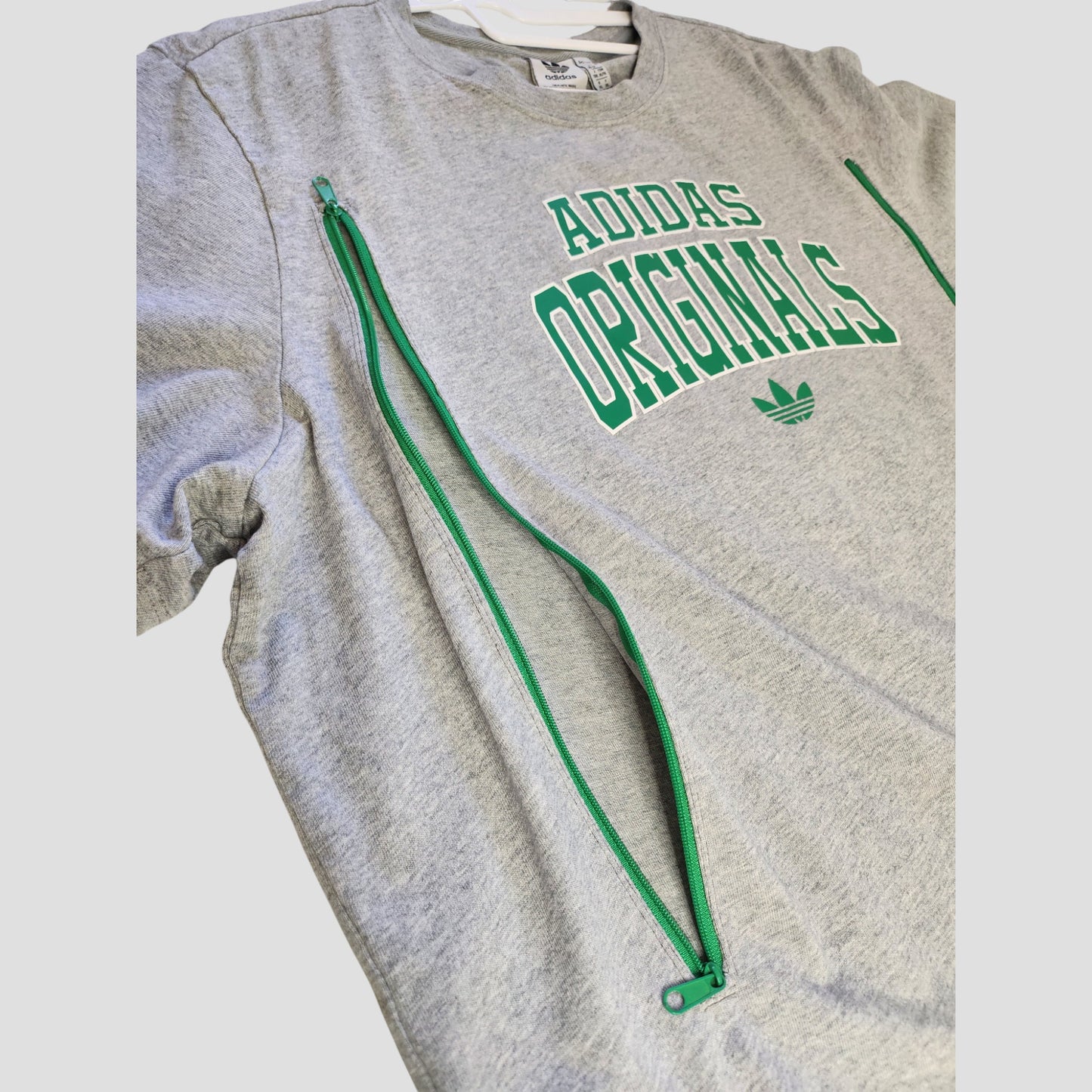 An upcycled Adidas Originals t-shirt (XL, UK20/22) in grey with eco-friendly design, green side zippers for nursing/pumping, and bold green ADIDAS ORIGINALS text plus logo on the front.