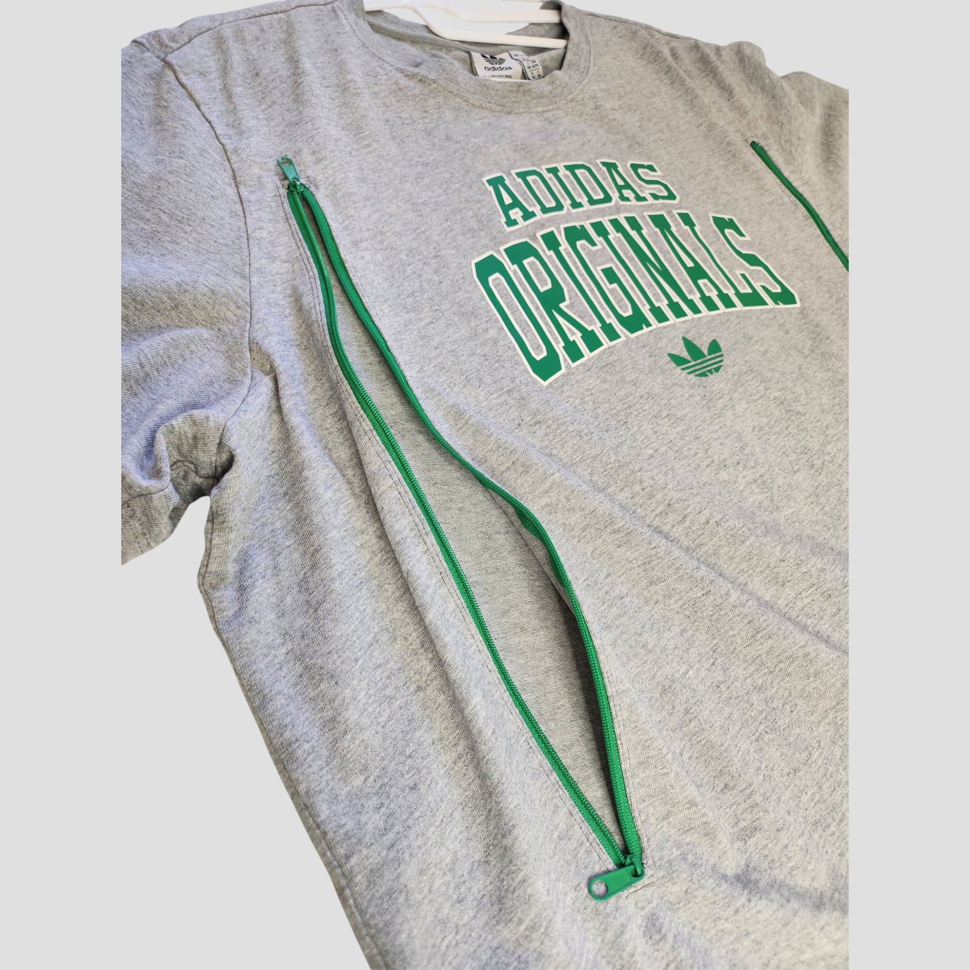 An upcycled Adidas Originals t-shirt (XL, UK20/22) in grey with eco-friendly design, green side zippers for nursing/pumping, and bold green ADIDAS ORIGINALS text plus logo on the front.