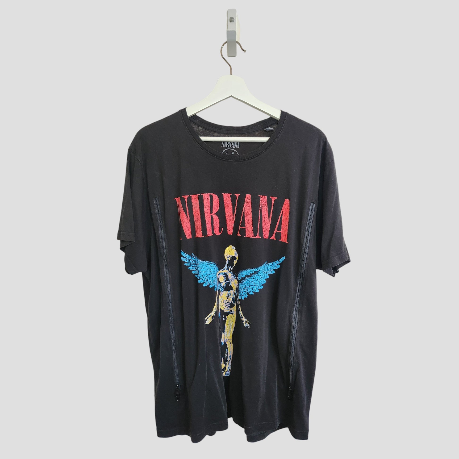 The Nirvana Upcycled Breastfeeding & Pumping Black/Turquoise Band T-shirt (XXL) features the band's logo and angel graphic—an eco-friendly, maternity style essential for nursing or pumping moms.