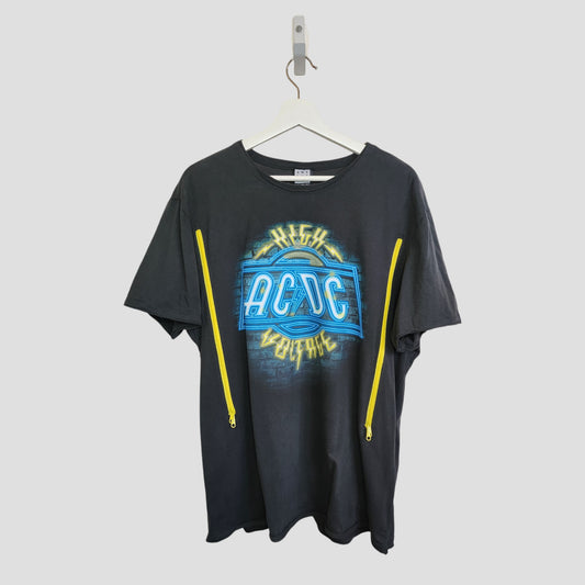 An upcycled Amplified AC/DC "High Voltage" grey XL band t-shirt (100317) for breastfeeding and pumping, with blue and yellow graphics plus diagonal yellow zippers on the front, hangs on a white hanger against a plain light gray background.