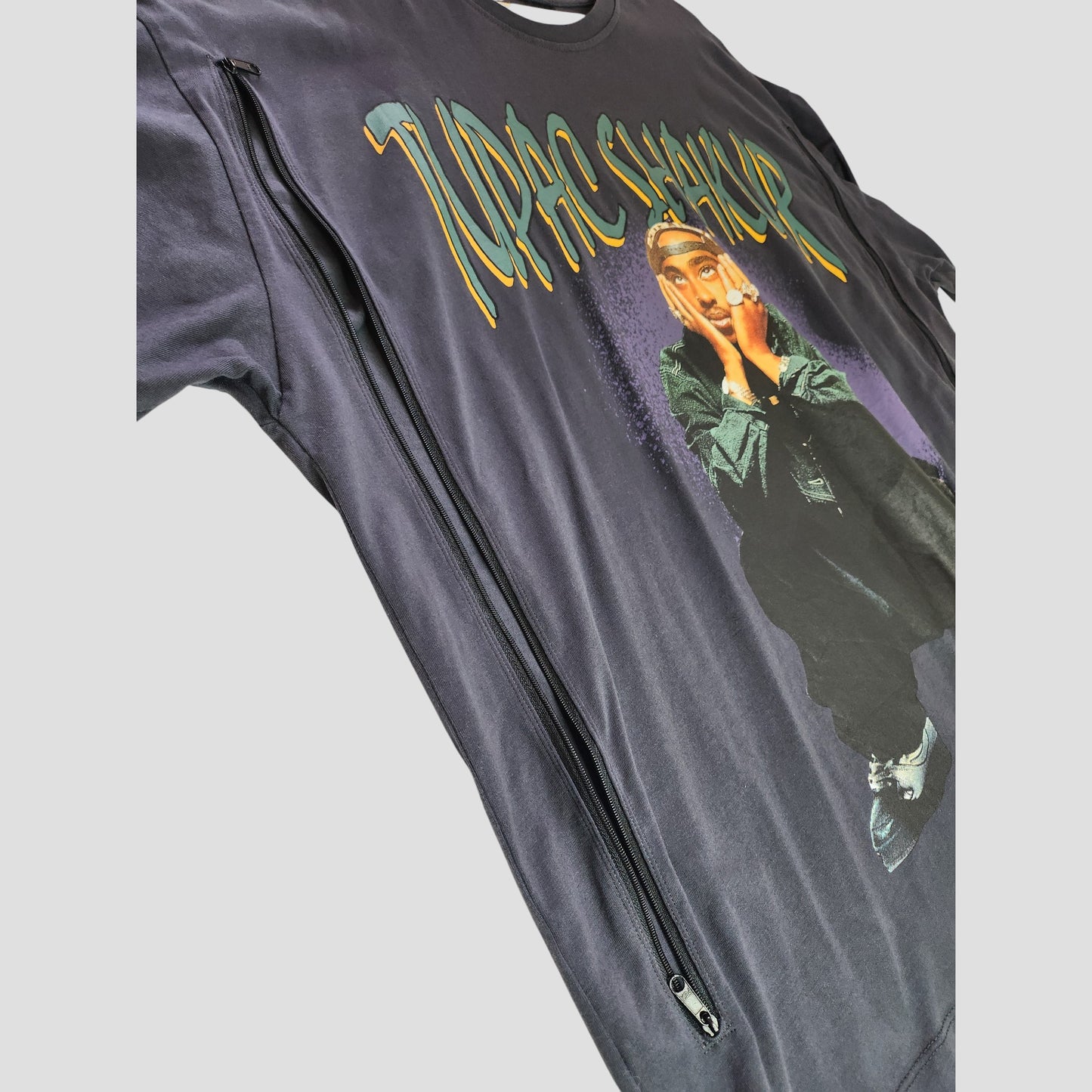 Primark’s Upcycled Breastfeeding & Pumping Black Tupac T-shirt (L, UK16/18) features Tupac Shakur graphics, yellow-green text, and a side zipper—eco-friendly maternity wear crafted from repurposed clothing.