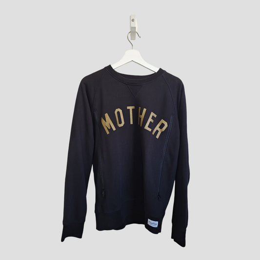 The Selfish Mother Upcycled Breastfeeding & Pumping Black/Gold MOTHER Sweatshirt (M, 100200) is an eco-friendly maternity top with "MOTHER" in bold yellow letters, shown on a white hanger against a light gray background.