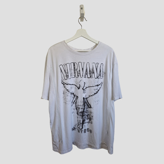 The Primark Upcycled Breastfeeding & Pumping Nirvana Angel Band T-shirt (3XL) features a white and black graphic with "NIRVANA" and an angel, plus "IN UTERO," hanging on a white hanger—an eco-friendly piece made from preloved clothing.