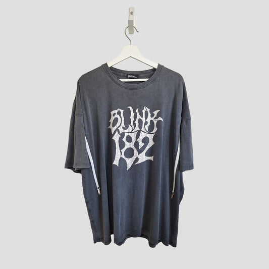 An affordable upcycled grey/white oversized Blink-182 band T-shirt by boohoo, designed for breastfeeding and pumping (M), hangs on a white hanger against a plain light gray background.