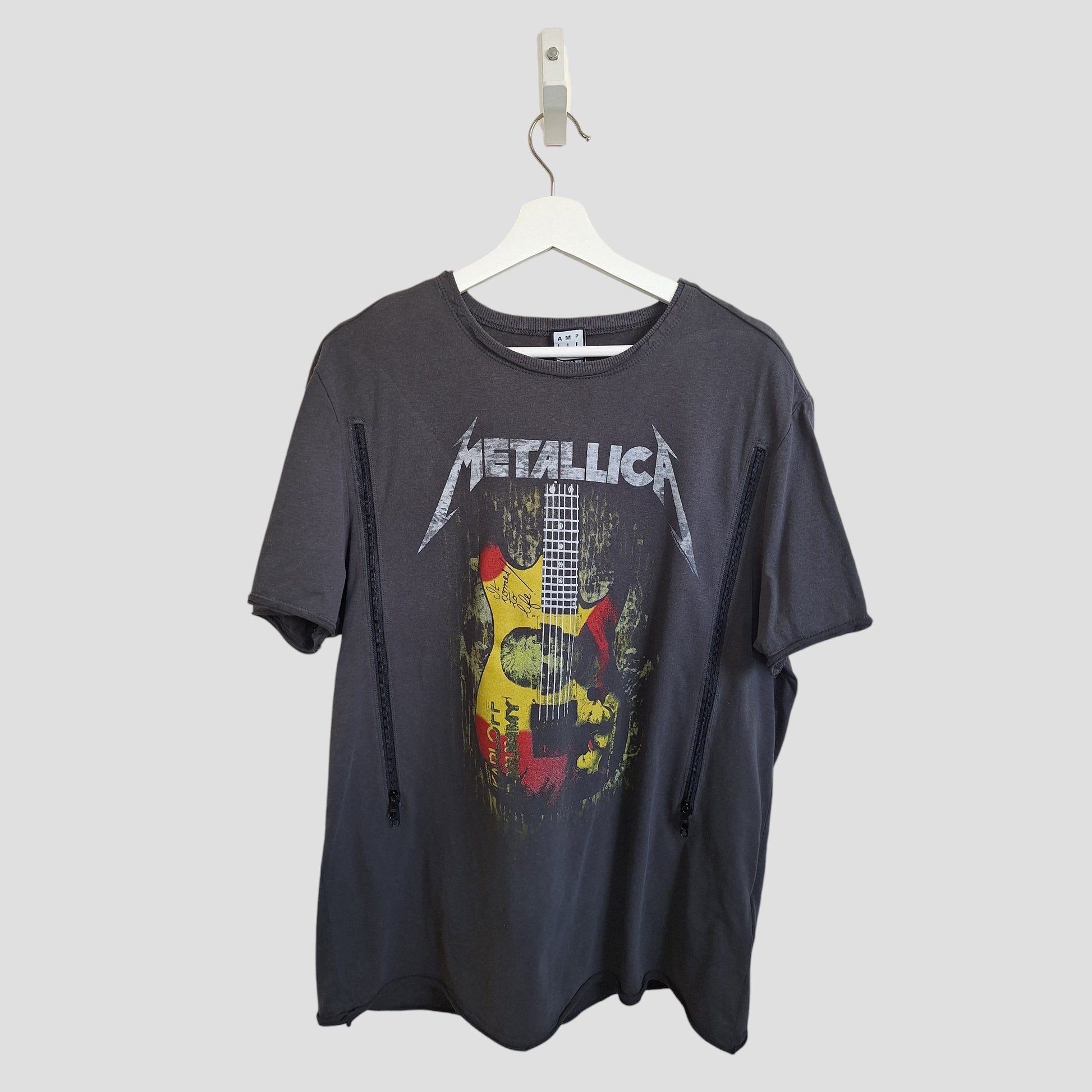 The Upcycled Amplified Breastfeeding & Pumping Metallica Guitar Band T-shirt XL (100353) in black features a red and yellow guitar graphic—an eco-friendly, affordable choice from our preloved collection. Displayed on a white hanger.