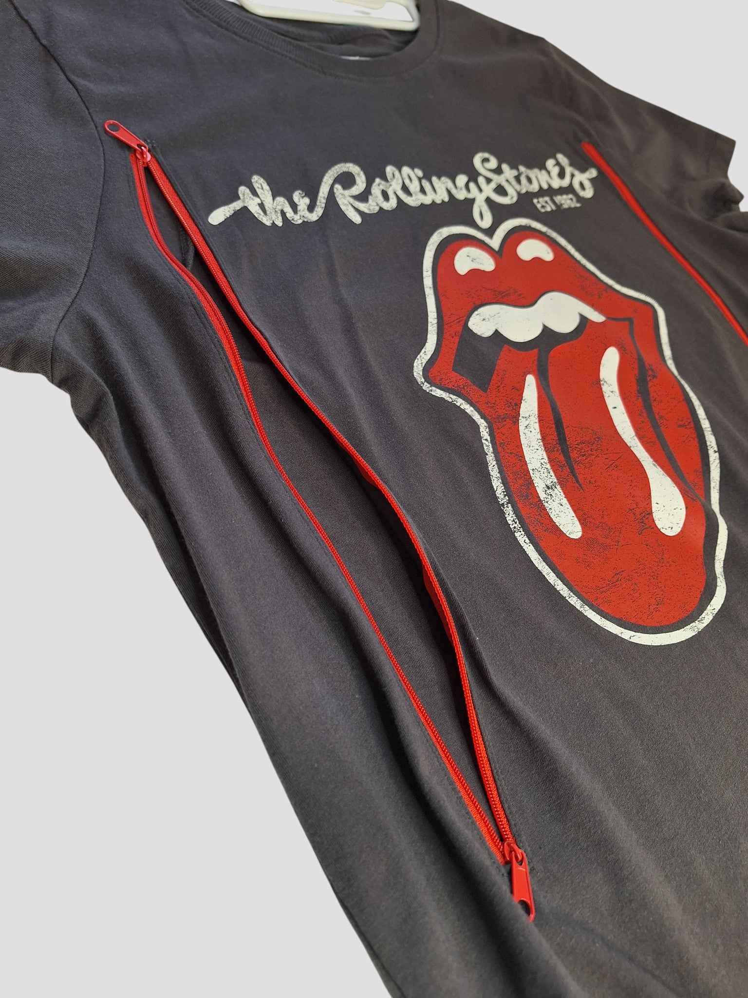 An upcycled grey Primark Rolling Stones band t-shirt (L, 100335) designed for breastfeeding and pumping—sustainable preloved clothing with iconic logo for unique eco-friendly style.