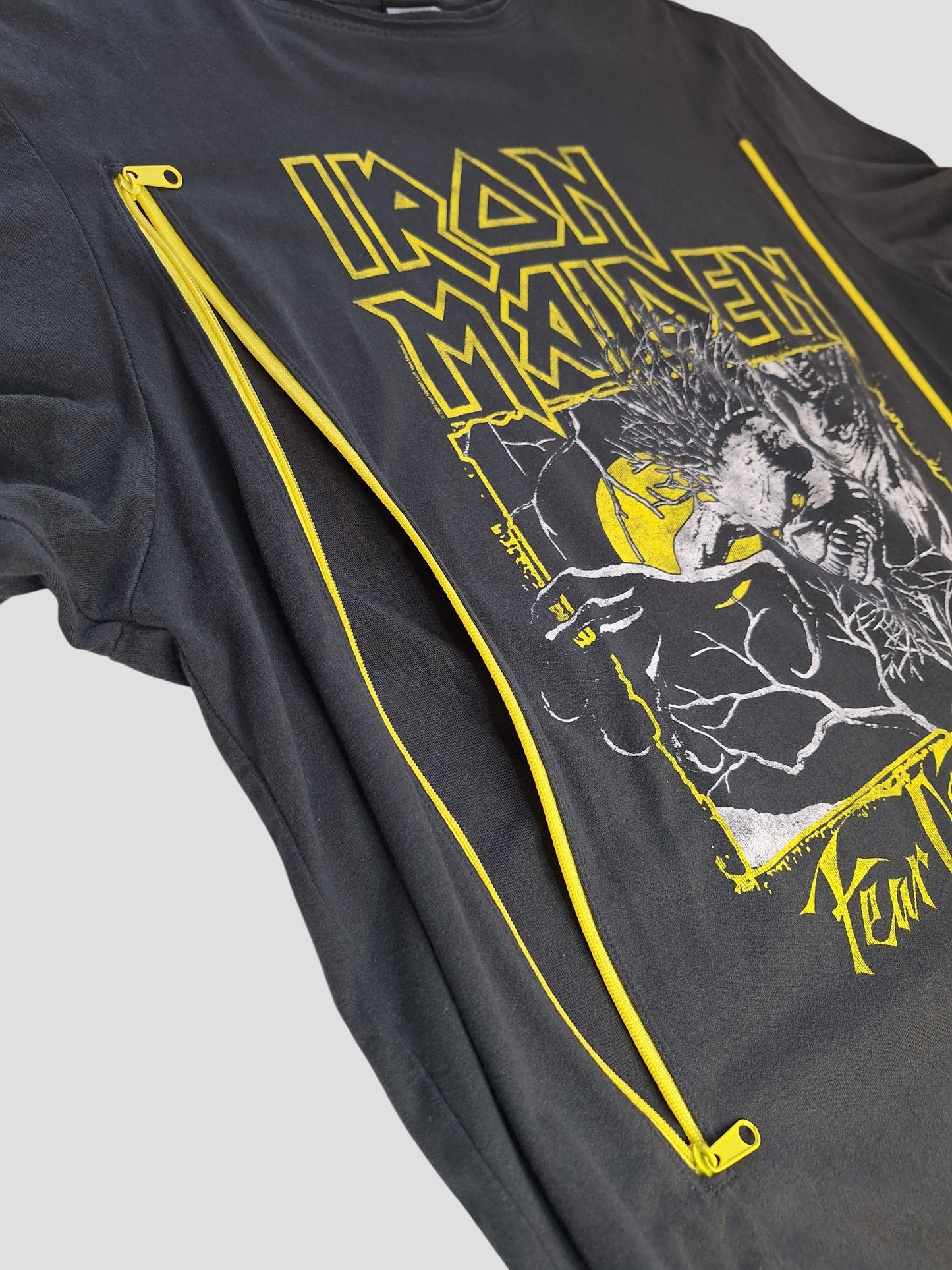 Amplified Upcycled Breastfeeding & Pumping Grey/Yellow Iron Maiden Band T-shirt (L, 100352) features yellow graphics and two diagonal yellow zippers on the front, photographed against a plain light background.